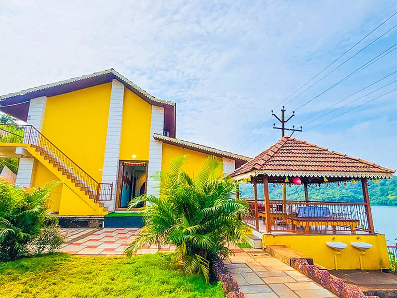 Outdoor garden view of Andur Lakeview Resort with greenery and walking path