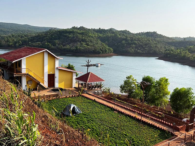 Lawn and sports area at Andur Lakeview Resort featuring open green space, outdoor games, and relaxing seating