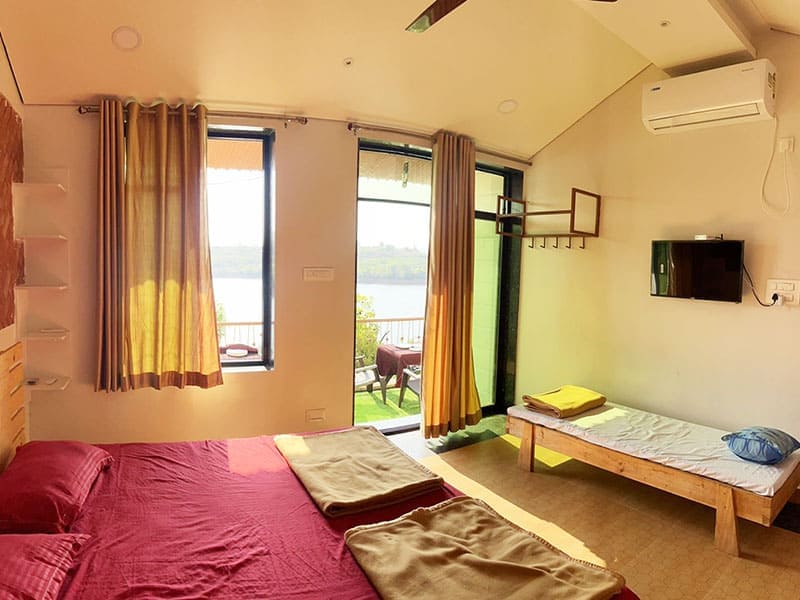 Deluxe room at Andur Lakeview Resort with lake view and comfortable bedding
