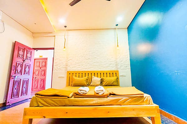 Deluxe Room with AC, TV, and clean attached washroom accommodating 3–4 guests at Andur Lakeview Resort